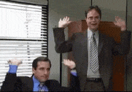 Two characters from The Office celebrating with their hands raised in the air.